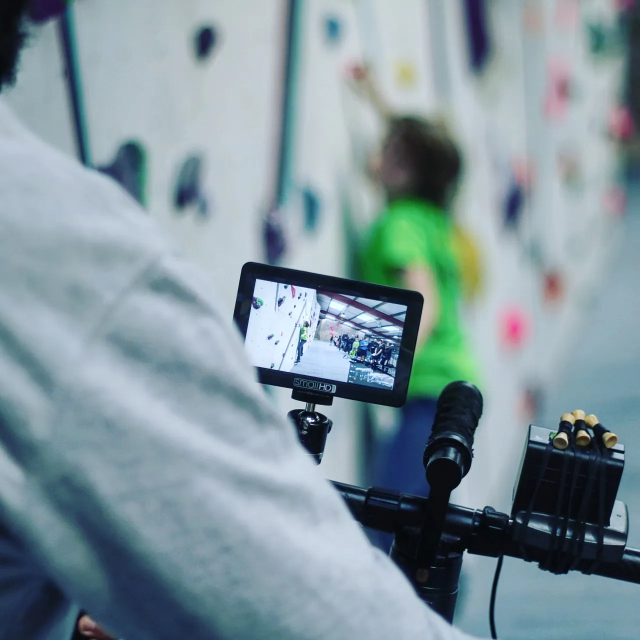 Climber attempting a FAQ-themed bouldering problem